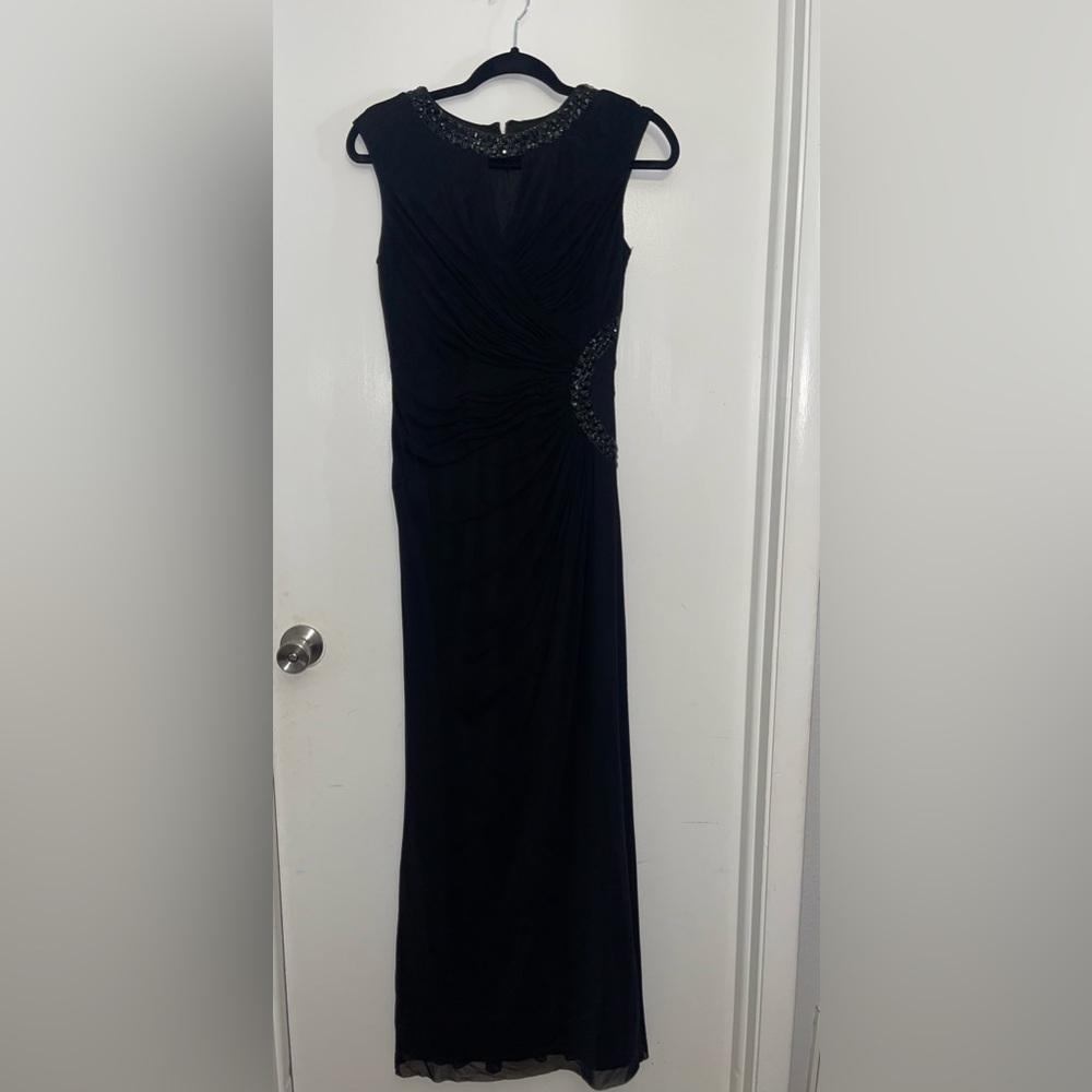 Black, long, sleeves dress. Ruffled in the front and back. form fitting.